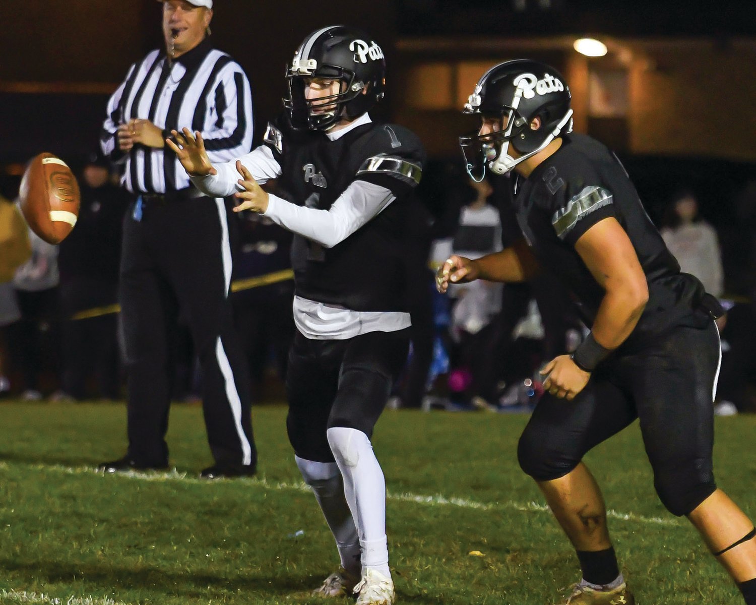 SENIOR LEADERS: Pilgrim quarterback Connor Widmer looks to take the snap to hand the ball off to Danny Halliwell.